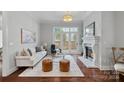 Cozy living room featuring a fireplace, plush seating, and access to a charming outdoor patio at 8812 Provence Village Ln, Charlotte, NC 28226