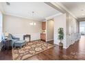 Cozy living room with hardwood floors, chair rail, and a decorative rug at 8823 Bur Ln, Huntersville, NC 28078