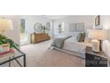 Cozy bedroom with ample natural light, walk-out to the backyard, and neutral decor at 9239 Delancey Nw Ln, Concord, NC 28027