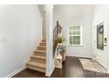 Bright entryway featuring hardwood floors, staircase and a decorative console table, with easy access at 1037 Delridge St, Waxhaw, NC 28173