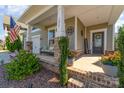 Inviting covered front porch with stone pillars, cozy seating, and a 'Welcome' sign at 1037 Delridge St, Waxhaw, NC 28173