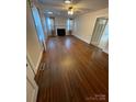 Spacious living room with gleaming hardwood floors and a cozy fireplace at 10516 Hambright Rd, Huntersville, NC 28078