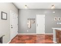 Inviting foyer with hardwood floors, coat rack, and neutral gray walls at 114 Clydesdale Ct, Matthews, NC 28104