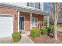 Welcoming front door with brick surround, decorative columns, and tidy landscaping at 114 Clydesdale Ct, Matthews, NC 28104