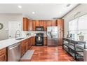 Well-equipped kitchen with stainless steel appliances, rich wood cabinets, and tiled backsplash at 114 Clydesdale Ct, Matthews, NC 28104