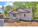 Exterior view of a house with trees in the background and construction supplies in the yard at 1235 E Poplar St, Conover, NC 28613