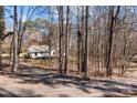 Scenic driveway winds through a secluded wooded lot leading up to the home at 12538 Sam Furr Rd, Huntersville, NC 28146