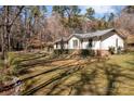 A charming single-story home with a well-manicured lawn and mature trees that offer privacy at 12538 Sam Furr Rd, Huntersville, NC 28146