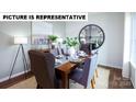 Elegant dining room featuring a wooden table, stylish chairs, and modern decor at 132 Woodhall Way, Troutman, NC 28166
