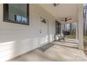 Inviting front porch with seating, a ceiling fan, and ample space to relax at 13625 Buster Rd, Stanfield, NC 28163