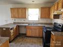 Outdated kitchen featuring wooden cabinets, counters and flooring at 1421 Braveheart Ln, Charlotte, NC 28216