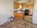 Dated kitchen featuring wooden cabinets, counters and flooring at 1421 Braveheart Ln, Charlotte, NC 28216