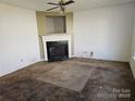 Living room with fireplace and ceiling fan at 1421 Braveheart Ln, Charlotte, NC 28216