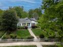 Inviting home featuring a lush front yard, mature landscaping, and a classic white picket fence at 1519 The Plz, Charlotte, NC 28205