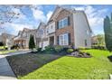 Two-story home boasting a well-manicured lawn and charming architectural details at 1857 Felts Pkwy, Fort Mill, SC 29715