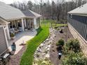 Expansive backyard featuring a screened in porch, landscaped garden, and well-maintained lawn at 2011 Trailwood Dr, Matthews, NC 28104