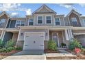 Attractive two-story townhome with a one-car garage, gray and brick facade, and landscaped front yard at 2149 Bexar Trl, Matthews, NC 28105