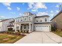 Beautiful two-story home with white trim, dormer windows, and an attached two-car garage at 261 Supernova Dr, York, SC 29745
