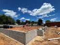 Concrete foundation of new construction home against a partly cloudy sky at 3003 Casting St # 12, Charlotte, NC 28206