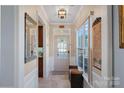 Inviting foyer with decorative mirror, tiled floor, and sunlit windows at 3100 Azalea Dr, Fort Mill, SC 29707