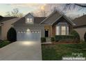 Charming home with a two-car garage, stone accents, and well-maintained landscaping at 3104 Streamhaven Dr, Indian Land, SC 29707