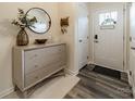 Inviting entryway featuring a round mirror, three-drawer cabinet, and stylish decor at 3104 Timber Mill Dr, Matthews, NC 28104