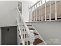 Elegant staircase featuring white railing and wooden steps at 326 Whispering Pines Dr, Charlotte, NC 28217