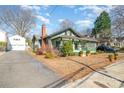 Side view of the craftsman-style home with a long driveway and a detached garage at 36 Yorktown Nw St, Concord, NC 28025