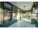 Cozy porch showcasing classic design with views of front yard and neighborhood; natural light through large windows at 36 Yorktown Nw St, Concord, NC 28025