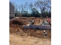 New home foundation being built with dirt and utility pipes at the construction site at 4127 Walking Ridge Rd # 53, Charlotte, NC 28208