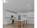 Modern kitchen with white cabinets, island, and stainless steel appliances at 4127 Walking Ridge Rd # 53, Charlotte, NC 28208