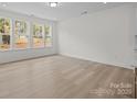 Bright living room with hardwood floors and large windows allowing natural light to flood the space at 4127 Walking Ridge Rd # 53, Charlotte, NC 28208
