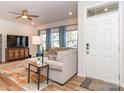 Bright living room with large sectional couch, modern lighting, and front door at 426 Kenwood Vw, Indian Trail, NC 28079