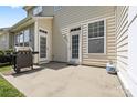 Back patio area with a grill and double doors leading into the home at 5959 Pale Moss Ln, Charlotte, NC 28269