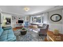 Bright living area featuring hardwood floors, large window, and tasteful decor at 6823 City View Dr, Charlotte, NC 28212
