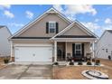 Charming single-Gathering home with a well-manicured lawn, inviting front porch and attached two car garage at 7172 Indigo Way, Denver, NC 28037