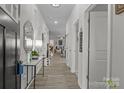 Spacious hallway with modern decor, neutral paint and updated flooring leads to the home's living spaces at 7172 Indigo Way, Denver, NC 28037