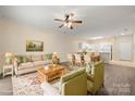 Inviting living space with a cozy sofa, chairs, and a view into the dining area and kitchen at 8617 Coralbell Ln, Charlotte, NC 28213
