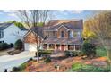 A stunning aerial view showcases the brick home, lush landscaping, and front yard at 8622 Ellington Park Dr, Charlotte, NC 28277
