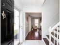 Inviting entryway featuring hardwood floors and staircase leading to the upper level at 9709 Cloverwood Ct, Charlotte, NC 28270