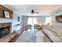 Spacious living room featuring a stone fireplace, modern decor, and seamless flow at 9709 Cloverwood Ct, Charlotte, NC 28270