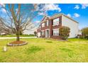 Beautiful two-story brick home with well-maintained lawn and landscaping at 10223 Kelso Ct, Charlotte, NC 28278