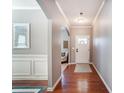 Elegant foyer with hardwood floors, wainscoting, and an arched doorway leading to other areas of the home at 10321 Solar Way, Charlotte, NC 28278