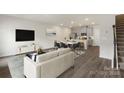 Open floor plan with lots of sunlight featuring modern furnishings and a kitchen with stainless steel appliances at 104 Ciara Pl # B, Mooresville, NC 28117