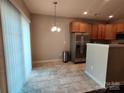 Bright dining area with stainless steel appliances and sliding glass door at 11148 Kanturk Ct, Charlotte, NC 28213