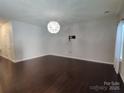 Spacious living room featuring hardwood floors and a modern light fixture at 11148 Kanturk Ct, Charlotte, NC 28213