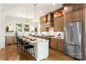 Beautiful kitchen features a large island with seating, stainless steel appliances, and wood cabinets at 1119 N Myers St, Charlotte, NC 28206