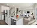 Modern kitchen with granite countertops, stainless steel appliances, and an island that opens up to the dining area at 117 Obadiah Ct, Troutman, NC 28115
