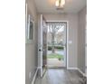 View of the front yard through the open front door, with wood-look flooring in the entryway at 11911 Maria Ester Ct, Charlotte, NC 28277