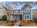 Charming two-story home with a well-manicured front yard and inviting porch at 12545 Druids Glen Dr, Pineville, NC 28134
